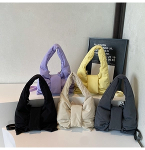 Quilted bow handbags in five colors displayed on white steps for 2025 fashion collection