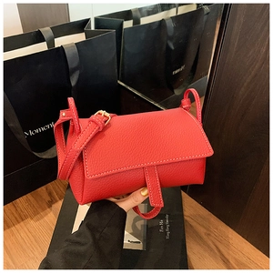 Red textured leather pillow bag with gold clasp and adjustable strap for women
