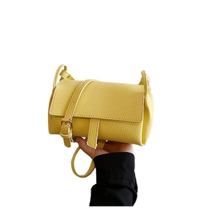 Minimalist yellow leather pillow bag with lychee texture and adjustable shoulder strap