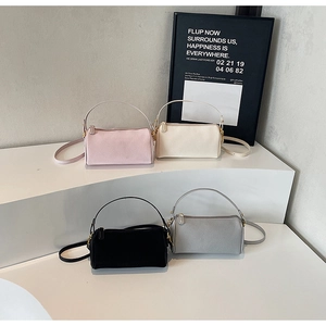 Fashionable cylinder handbags in pink, white, black and gray with leather texture