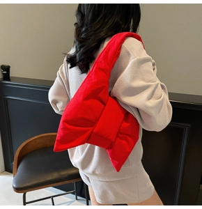 Detailed back view of a bright red oversized bow tote bag in quilted cotton fabric
