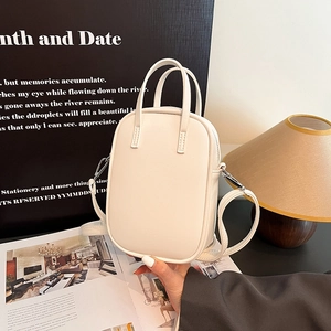Minimalist white faux leather tote bag with dual handles and detachable shoulder strap