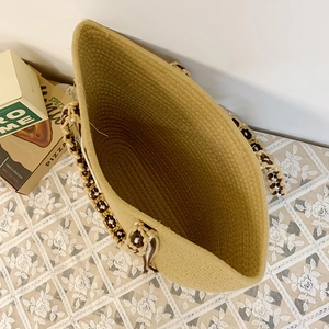 Detail of hand-woven straw tote bag showing interior capacity and rope handle texture