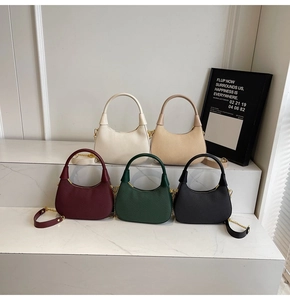 Detail of five structured handbags in various colors with elegant woven texture and chain strap