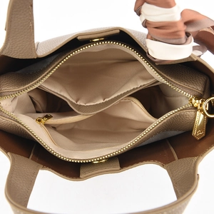 Interior view of brown pebble leather tote bag showing compartments and silk scarf detail