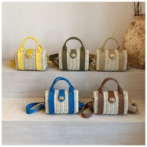 Detailed row of woven straw handbags in five colors with canvas straps and metal locks