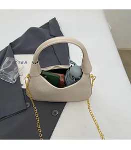 Top view of cream dumpling bag interior showing capacity for wallet and mini umbrella