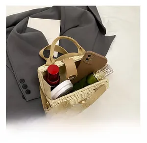 Top view of woven straw tote bag interior showing capacity for cosmetics and phone