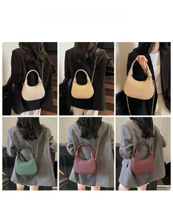 Detail view of stylish textured hobo bag with gold chain strap in four colors