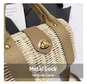Detail of woven straw handbag featuring gold metal twist lock and beige leather strap