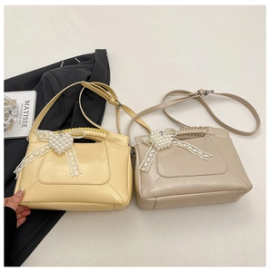 Detail of elegant handbags with pearl heart bows, lace edges, and adjustable leather straps