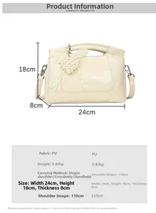 Creamy white crossbody bag with pearl heart and bow charm, measuring 24x18x8cm