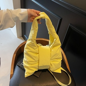 Chic yellow puffy tote bag with bow design and long shoulder strap for women