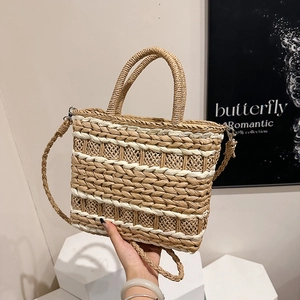 Chic straw woven tote bag with white fiber stitching and adjustable strap for summer travel