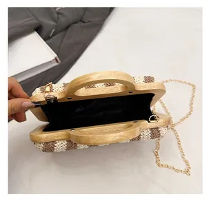 Detail of woven striped handbag featuring wooden handle and black silk lining