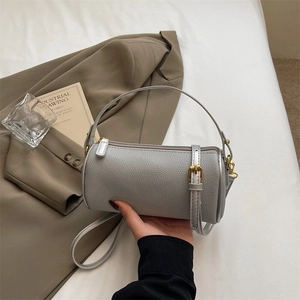 Chic grey lychee leather cylinder bag with gold hardware for fashion commuting style