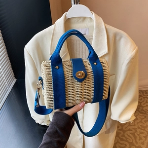 Fashionable beige woven straw handbag with blue strap and gold twist lock closure