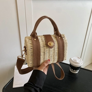 Handwoven straw tote bag with brown leather flap and adjustable strap for summer beach