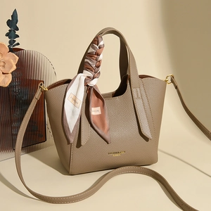 Elegant khaki lychee leather bucket bag with silk scarf handle and golden hardware