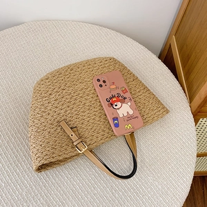 Pink phone case with cute dog and fast food patterns resting on a woven bag