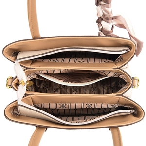 Interior view showing multiple compartments and silk scarf detail of the handbag