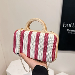 Handwoven straw tote with red and white stripes, wooden handle and metal chain shoulder strap
