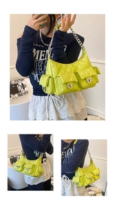 Detail view of lime green quilted patent leather underarm bag with silver chain strap