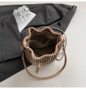 Interior view of pleated bucket bag showing zip pocket and spacious lining