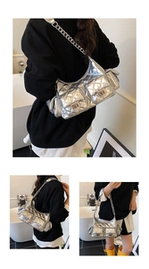 Detail showing the silver quilted shoulder bag with multiple pockets and chain strap