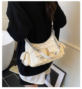 Close-up of quilted cream shoulder bag with silver twist locks and chain strap