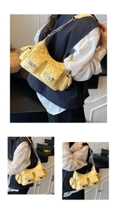 Detail of yellow quilted chain shoulder bag with silver hardware and pockets