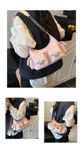 Detail of pink quilted shoulder bag with multi-pockets and silver metal turn locks