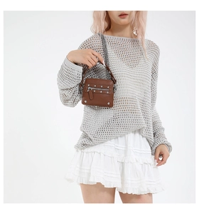 Detail of brown pebbled leather bag with silver studs and chain shoulder strap