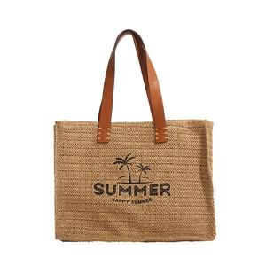 Woven straw summer tote bag with brown leather handles and coconut tree palm print