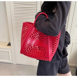 Détail du sac à main rouge ajouré avec motifs losanges pour la plage et le quotidien