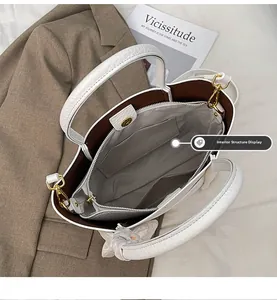 Internal structure of white tote bag with brown lining and middle zipper compartment