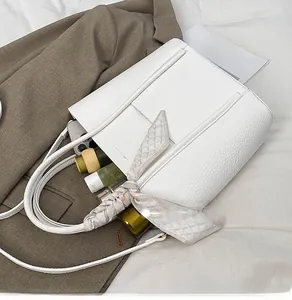 Close-up of white leather tote bag interior showing large capacity for personal essentials