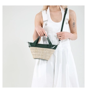 Detail of green leather and woven fabric crossbody bag with detachable strap