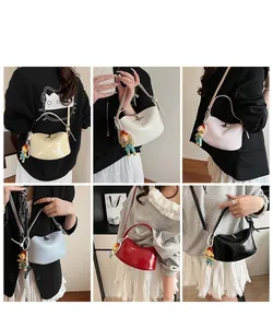 Detail view of stylish mini saddle bags in six colors with decorative doll pendants