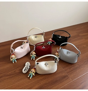 Detailed row of glossy patent leather handbags in assorted colors with metal cross locks
