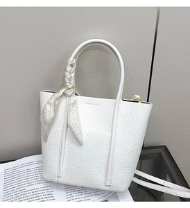 Detailed texture of white litchi pattern tote bag with decorative geometric silk scarf