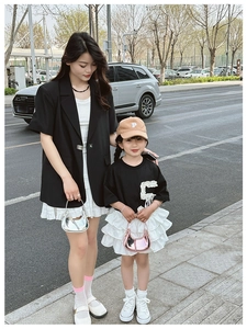 Close-up of a mini crescent bag with layered white skirt and chic urban casual styling