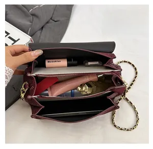 Detail view of woven leather chain bag interior showing multi-layer compartments and storage