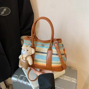 Colorful striped woven tote bag with brown leather trim and cute bear pendant charm
