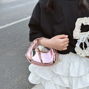 Close-up of a metallic rose pink crescent hobo bag with reflective mirror finish