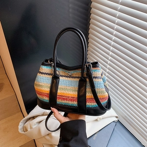 Colorful striped woven hobo bag with black leather straps and shoulder strap