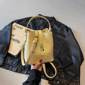 Fashionable cream crocodile pattern bucket bag with gold buckle and adjustable strap