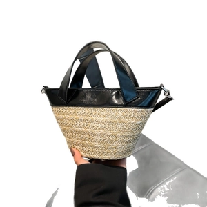 Fashionable woven straw tote bag with black leather trim and crossbody strap for women