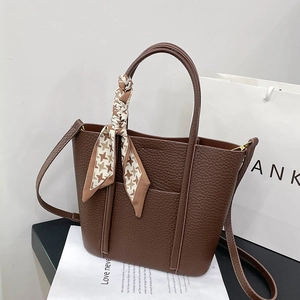 Brown litchi leather tote bag with stylish houndstooth scarf and long shoulder strap