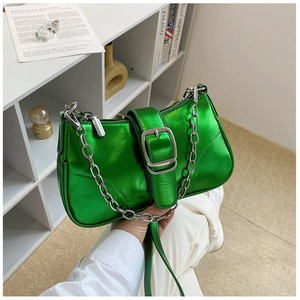 Dettaglio borsa a tracolla verde metallizzato lucido con catena d'argento e fibbia quadra